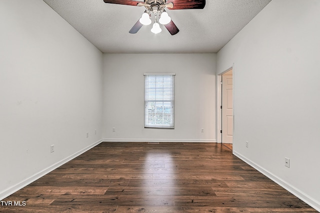 unfurnished room featuring baseboards, a textured ceiling, a ceiling fan, and dark wood finished floors