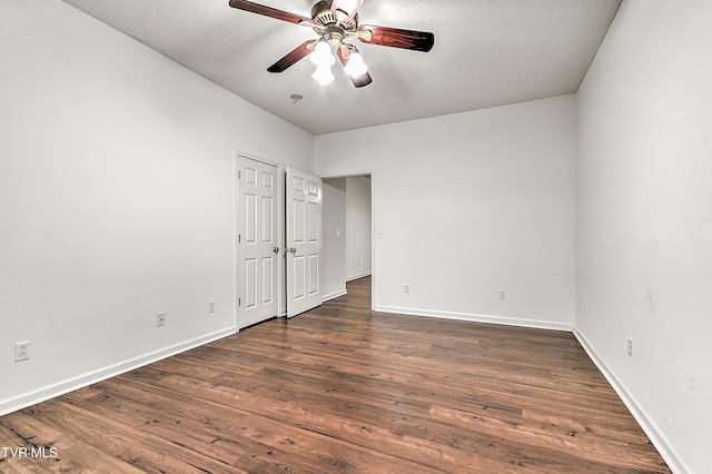 unfurnished bedroom featuring dark wood-style flooring, baseboards, ceiling fan, and a textured ceiling