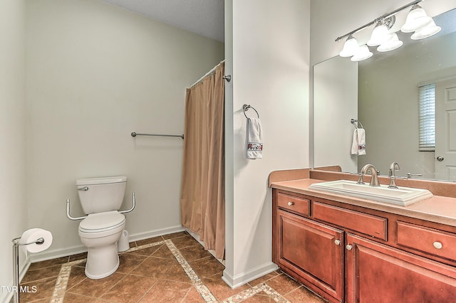 full bath with toilet, tile patterned floors, baseboards, and vanity