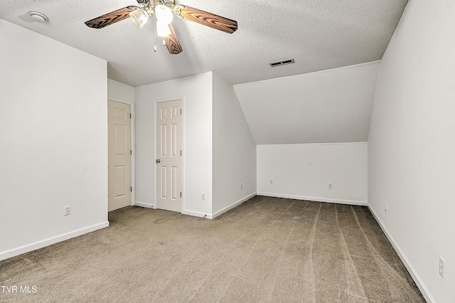bonus room with visible vents, baseboards, ceiling fan, a textured ceiling, and carpet flooring