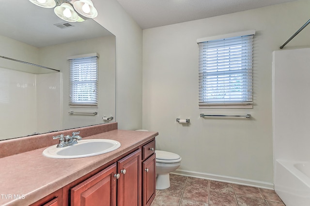 bathroom with vanity, baseboards, tile patterned floors, toilet, and visible vents