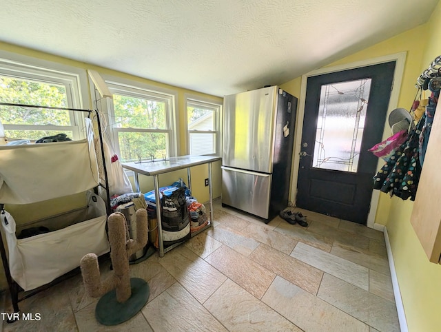 2509 Dc Caney Ridge Rd, Clintwood, VA 24228 - interior space with a textured ceiling, a healthy amount of sunlight, vaulted ceiling, and stone tile floors