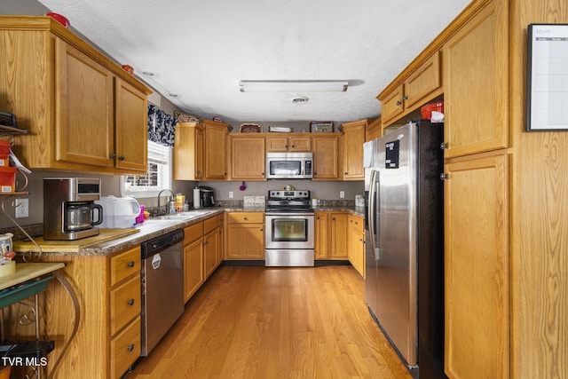 253 Crockett Dr Unit 253, Church Hill, TN 37642 - kitchen with light wood-type flooring, brown cabinets, a sink, and stainless steel appliances