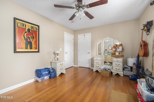 253 Crockett Dr Unit 253, Church Hill, TN 37642 - bedroom with a textured ceiling, wood finished floors, ceiling fan, and baseboards