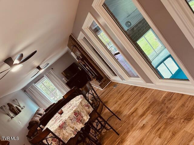 living room with wood finished floors and a towering ceiling