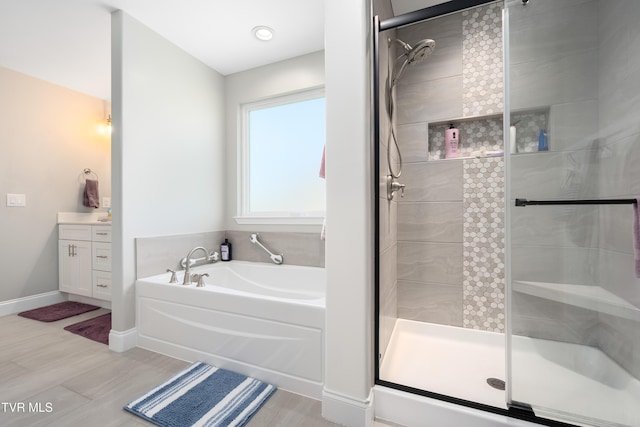 1177 Lemongrass Dr, Jonesborough, TN 37659 - bathroom featuring a shower stall, a garden tub, vanity, and baseboards