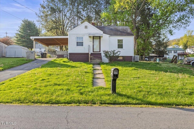 2510 Shelby St, Bristol, TN 37620 - bungalow-style home with aphalt driveway, a front lawn, fence, and an attached carport