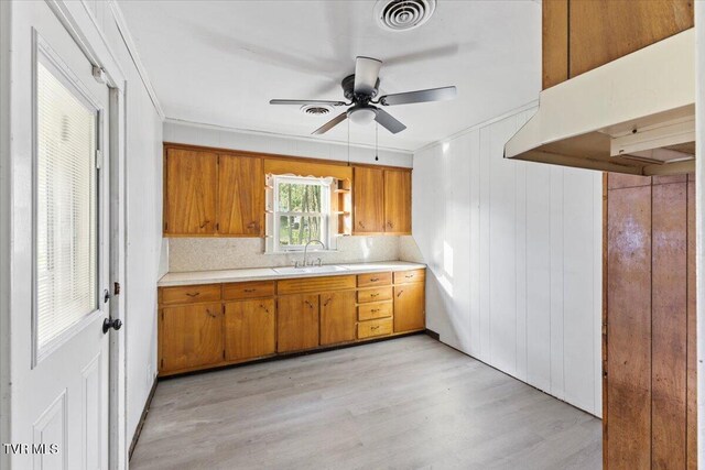 2510 Shelby St, Bristol, TN 37620 - kitchen with brown cabinetry, a sink, visible vents, and light countertops