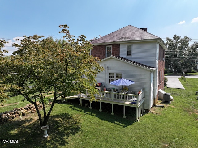 back of house featuring a deck, cooling unit, and a yard