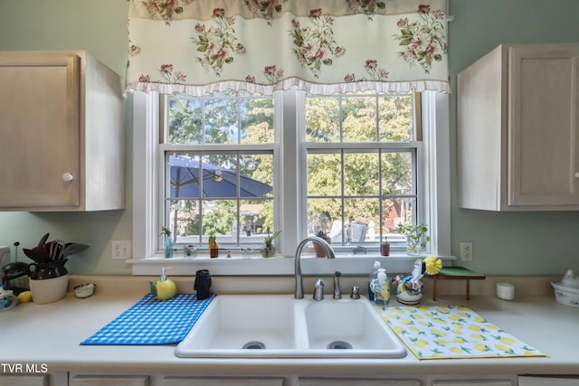 kitchen with plenty of natural light, light countertops, and a sink