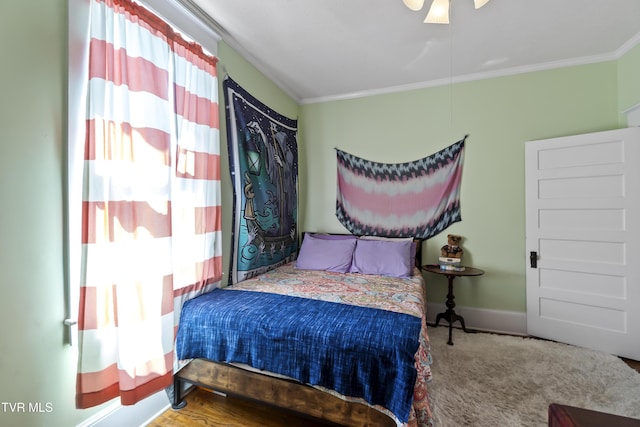 bedroom with multiple windows, ornamental molding, and baseboards