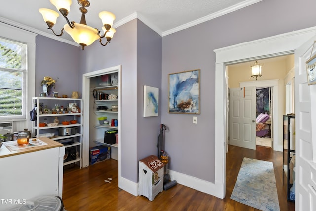 interior space featuring baseboards, wood finished floors, a notable chandelier, and ornamental molding