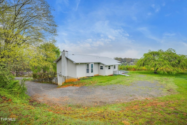 120 Lynnwood Dr, Johnson City, TN 37615 - back of property featuring a yard, metal roof, a chimney, and dirt driveway