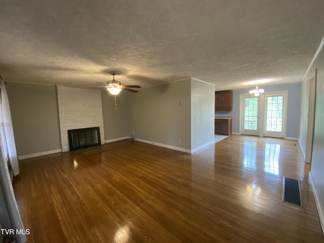 158 Taylortown Rd, Johnson City, TN 37601 - unfurnished living room featuring a textured ceiling, a fireplace, dark wood finished floors, and visible vents