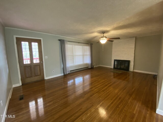 158 Taylortown Rd, Johnson City, TN 37601 - unfurnished living room featuring baseboard heating, a textured ceiling, wood finished floors, and a ceiling fan