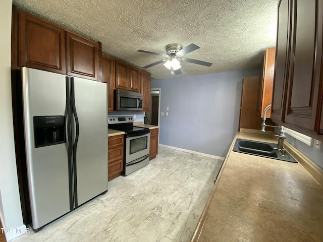 158 Taylortown Rd, Johnson City, TN 37601 - kitchen with a sink, light countertops, a ceiling fan, a textured ceiling, and stainless steel appliances