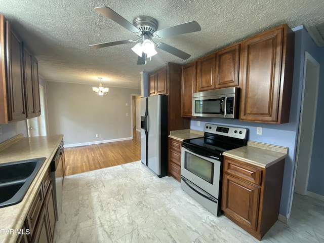 158 Taylortown Rd, Johnson City, TN 37601 - kitchen with a textured ceiling, light countertops, appliances with stainless steel finishes, ceiling fan with notable chandelier, and a sink