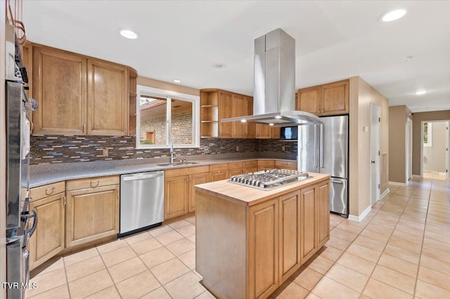 909 Millercrest Dr, Johnson City, TN 37604 - kitchen with light tile patterned floors, appliances with stainless steel finishes, island exhaust hood, a sink, and backsplash