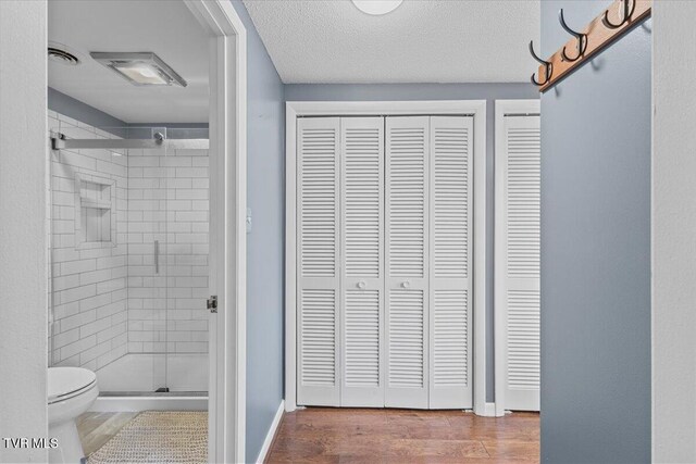 909 Millercrest Dr, Johnson City, TN 37604 - full bathroom with a closet, toilet, a shower stall, and wood finished floors