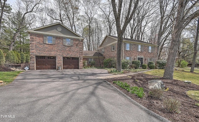 216 Forest Hills Dr, Bristol, TN 37620 - view of front facade with a garage, brick siding, and driveway