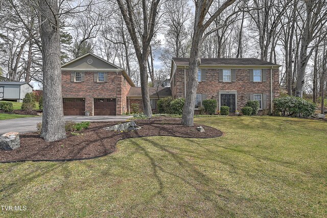 216 Forest Hills Dr, Bristol, TN 37620 - view of front of property with brick siding, driveway, an attached garage, and a front lawn