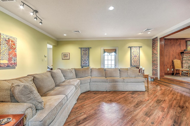 216 Forest Hills Dr, Bristol, TN 37620 - living area with visible vents, a textured ceiling, crown molding, and wood finished floors
