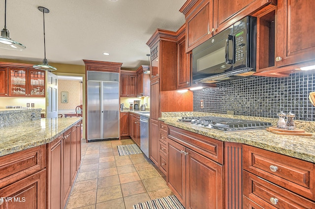 216 Forest Hills Dr, Bristol, TN 37620 - kitchen featuring glass insert cabinets, light stone countertops, hanging light fixtures, stainless steel appliances, and decorative backsplash