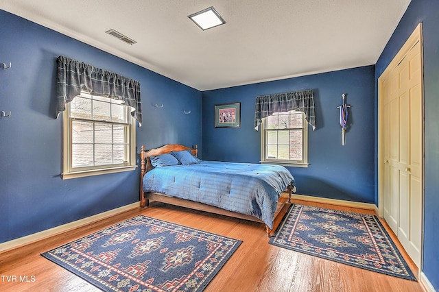 216 Forest Hills Dr, Bristol, TN 37620 - bedroom with visible vents, multiple windows, baseboards, and wood finished floors