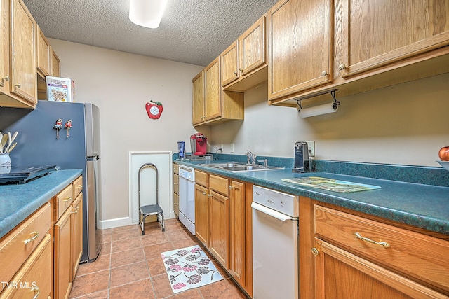 216 Forest Hills Dr, Bristol, TN 37620 - kitchen featuring freestanding refrigerator, a textured ceiling, light tile patterned flooring, a sink, and white dishwasher