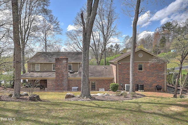216 Forest Hills Dr, Bristol, TN 37620 - view of side of property featuring brick siding, cooling unit, and a lawn