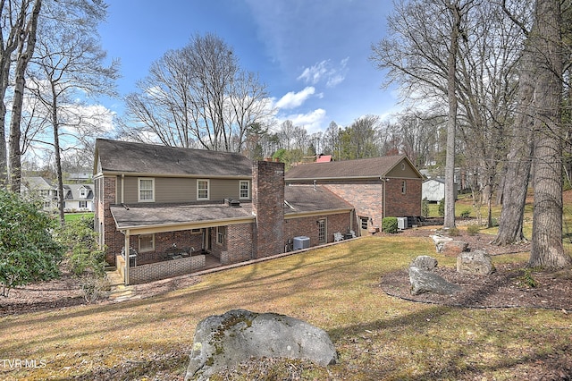 216 Forest Hills Dr, Bristol, TN 37620 - back of house with a yard, brick siding, a chimney, and a patio