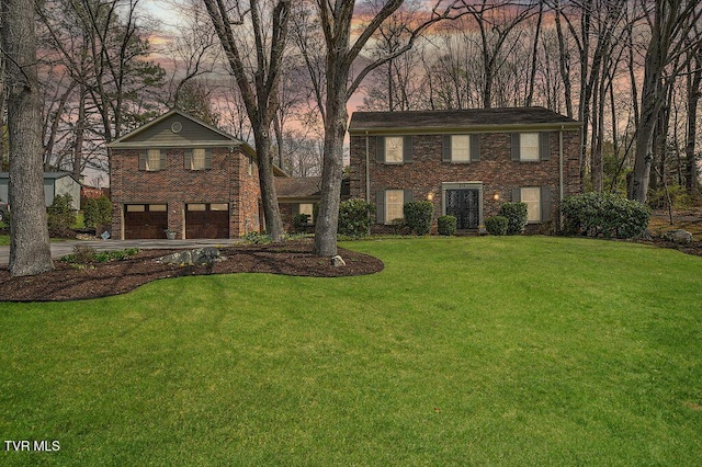 216 Forest Hills Dr, Bristol, TN 37620 - view of front of house with an attached garage, driveway, brick siding, and a lawn