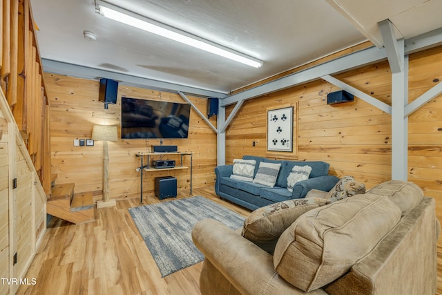 living area with wooden walls and wood finished floors