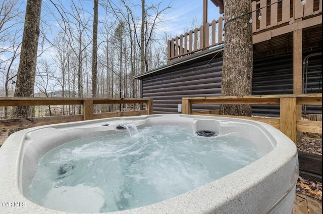 view of swimming pool with a hot tub