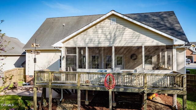 back of property with a patio area, fence, a sunroom, and a wooden deck