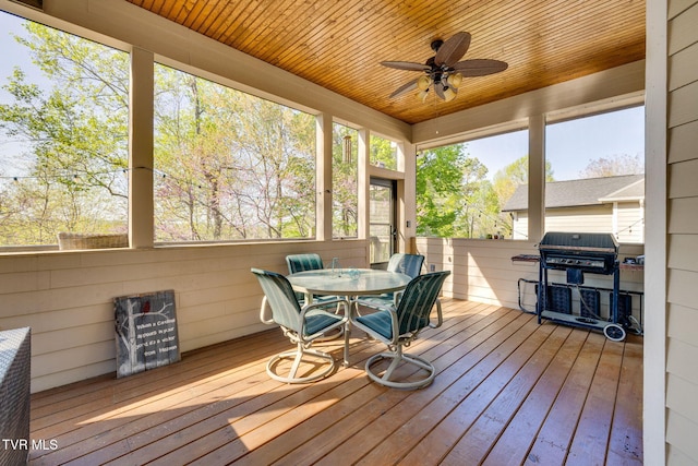 sunroom / solarium with ceiling fan, outdoor dining area, and a wealth of natural light