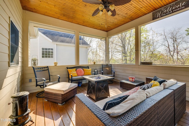 wooden terrace with an outdoor living space with a fire pit and a ceiling fan