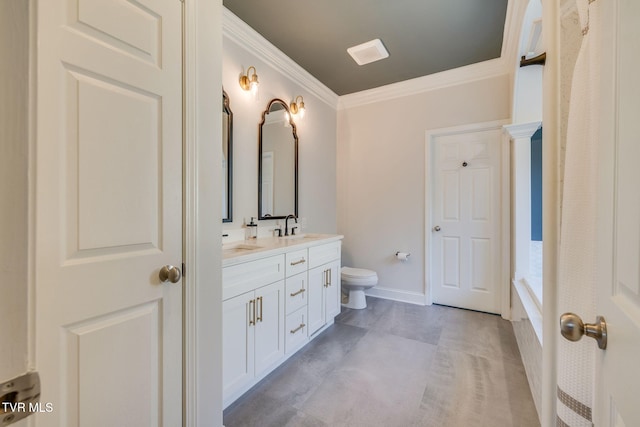 full bathroom with ornamental molding, toilet, a sink, double vanity, and baseboards
