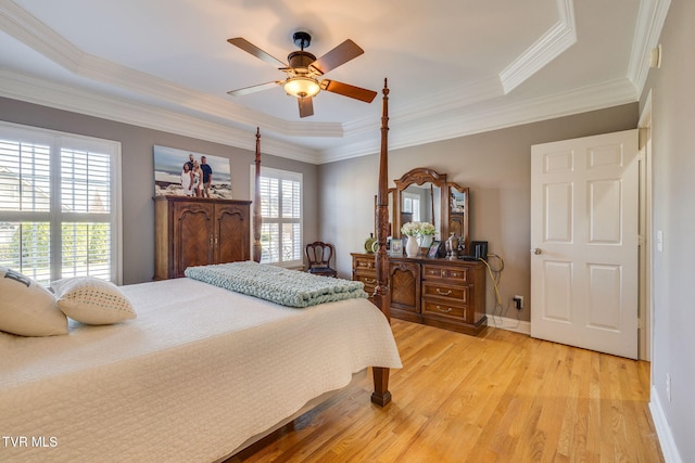 bedroom featuring a ceiling fan, light wood-type flooring, baseboards, and ornamental molding