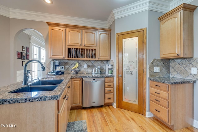 kitchen with arched walkways, dishwasher, a sink, and ornamental molding
