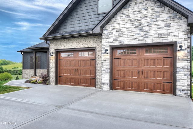 2442 Haystack Cir, Piney Flats, TN 37686 - view of front of home featuring stone siding, driveway, and an attached garage