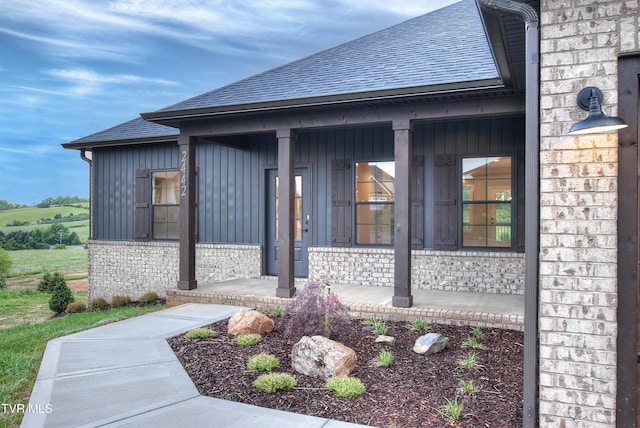 2442 Haystack Cir, Piney Flats, TN 37686 - entrance to property with a porch, a shingled roof, board and batten siding, and brick siding