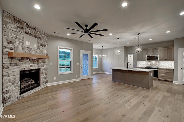 2442 Haystack Cir, Piney Flats, TN 37686 - kitchen with appliances with stainless steel finishes, open floor plan, a fireplace, a sink, and ceiling fan