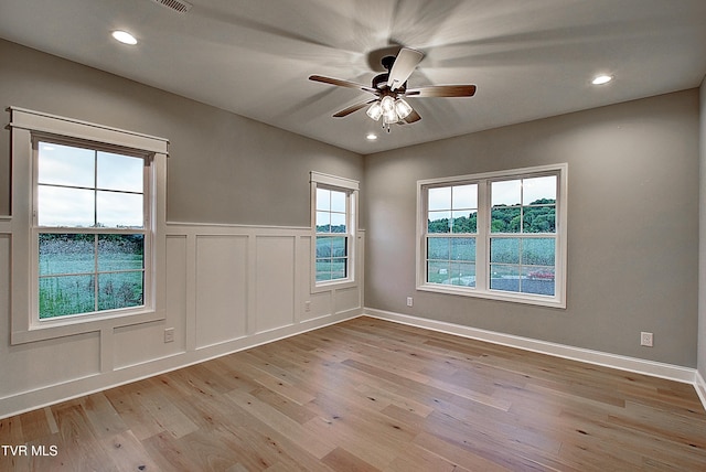 2442 Haystack Cir, Piney Flats, TN 37686 - empty room featuring light wood-type flooring, a ceiling fan, a decorative wall, recessed lighting, and wainscoting