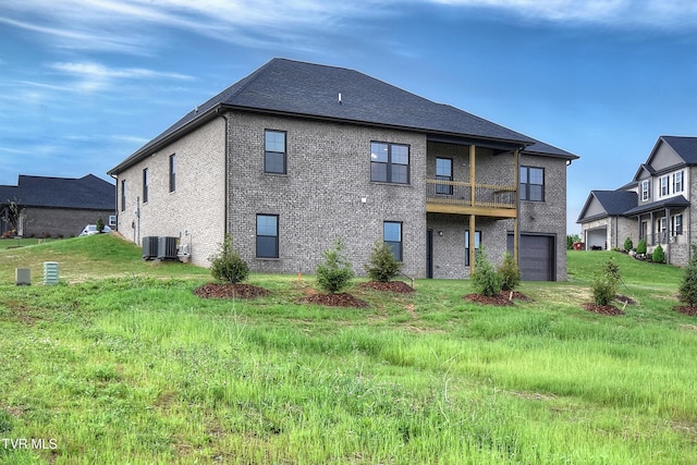 2442 Haystack Cir, Piney Flats, TN 37686 - rear view of house with a garage, brick siding, a balcony, central AC unit, and a yard
