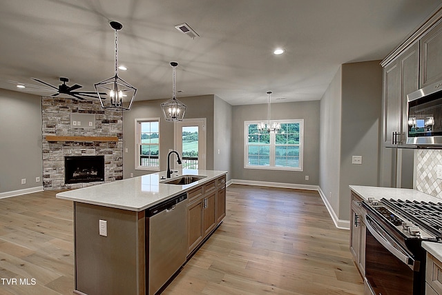 2442 Haystack Cir, Piney Flats, TN 37686 - kitchen with appliances with stainless steel finishes, a sink, ceiling fan, a fireplace, and a chandelier