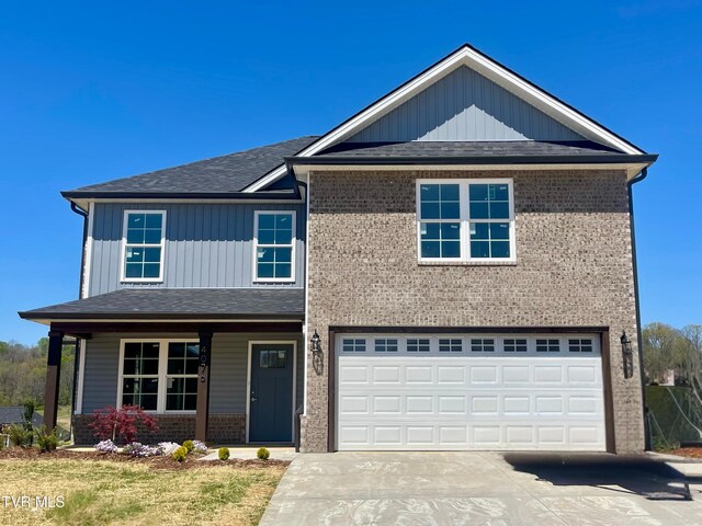 4076 Maize Pl, Piney Flats, TN 37686 - view of front of property featuring brick siding, concrete driveway, an attached garage, and covered porch