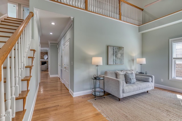 798 Hamilton Rd, Blountville, TN 37617 - living area with stairway, wood finished floors, baseboards, a high ceiling, and ornamental molding