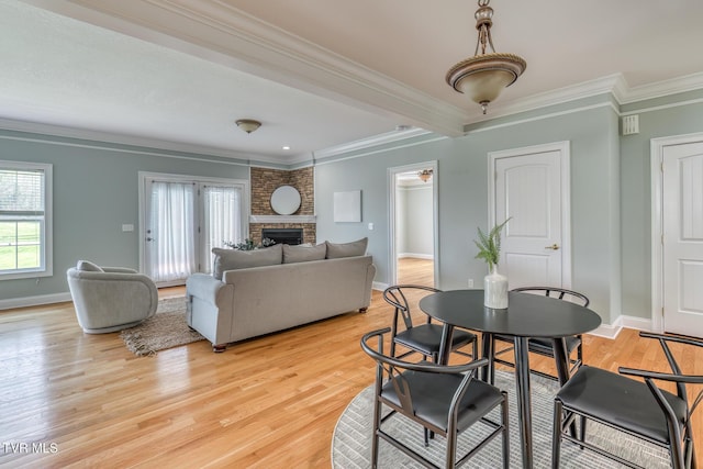 798 Hamilton Rd, Blountville, TN 37617 - dining area with crown molding, baseboards, light wood finished floors, and a fireplace