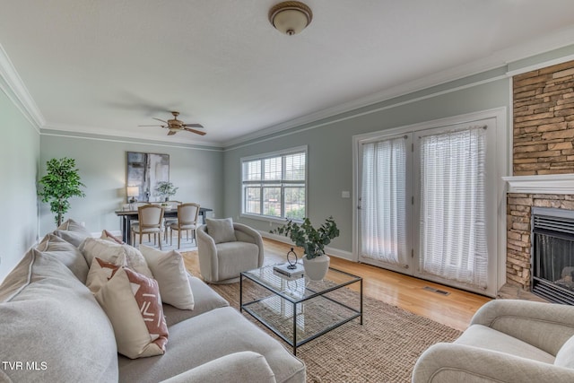 798 Hamilton Rd, Blountville, TN 37617 - living area with light wood-style flooring, ornamental molding, a ceiling fan, a fireplace, and baseboards